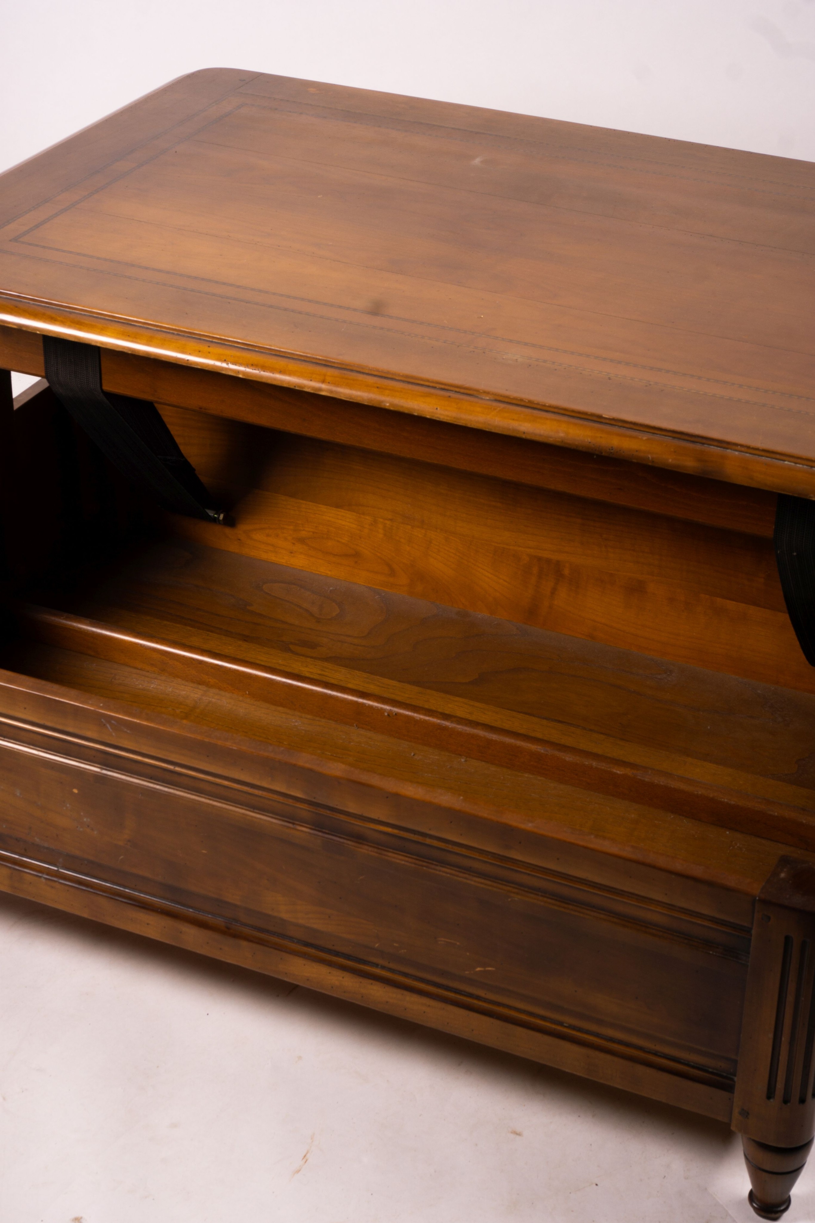 A reproduction rectangular walnut coffee table with rising top enclosing a wine bottle storage interior, length 130cm, depth 85cm, height 41cm